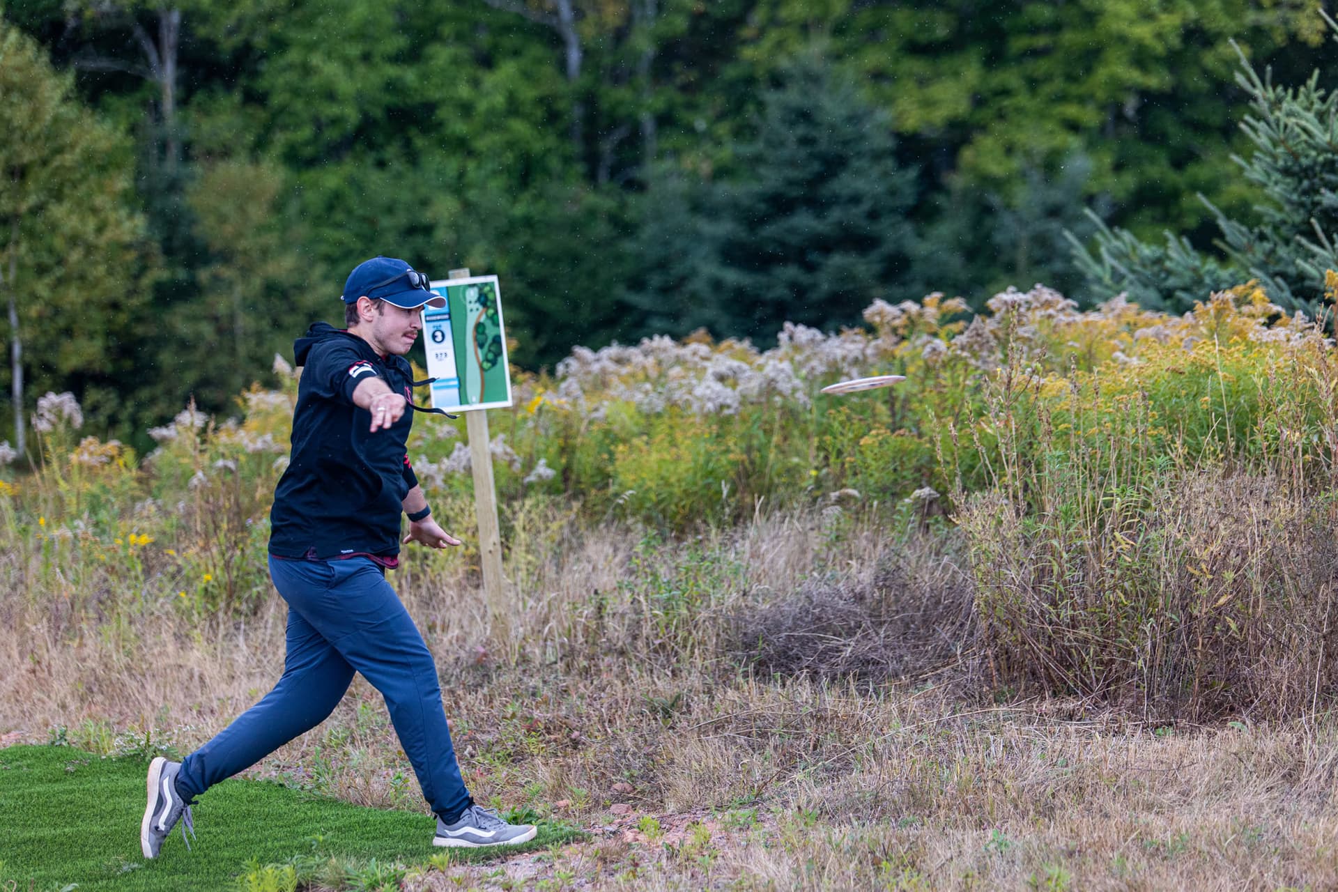 Driving off a grass tee pad into a wildflower meadow